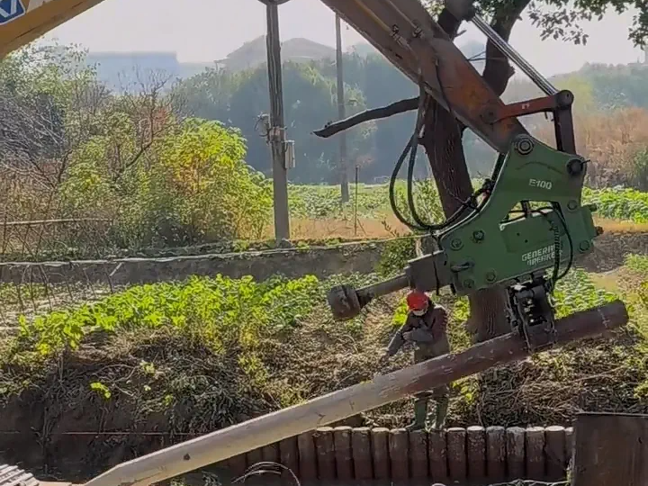 Breaker with rear-mounted clamp attachment installed for wooden post driving, hydraulic breaker post driving solution