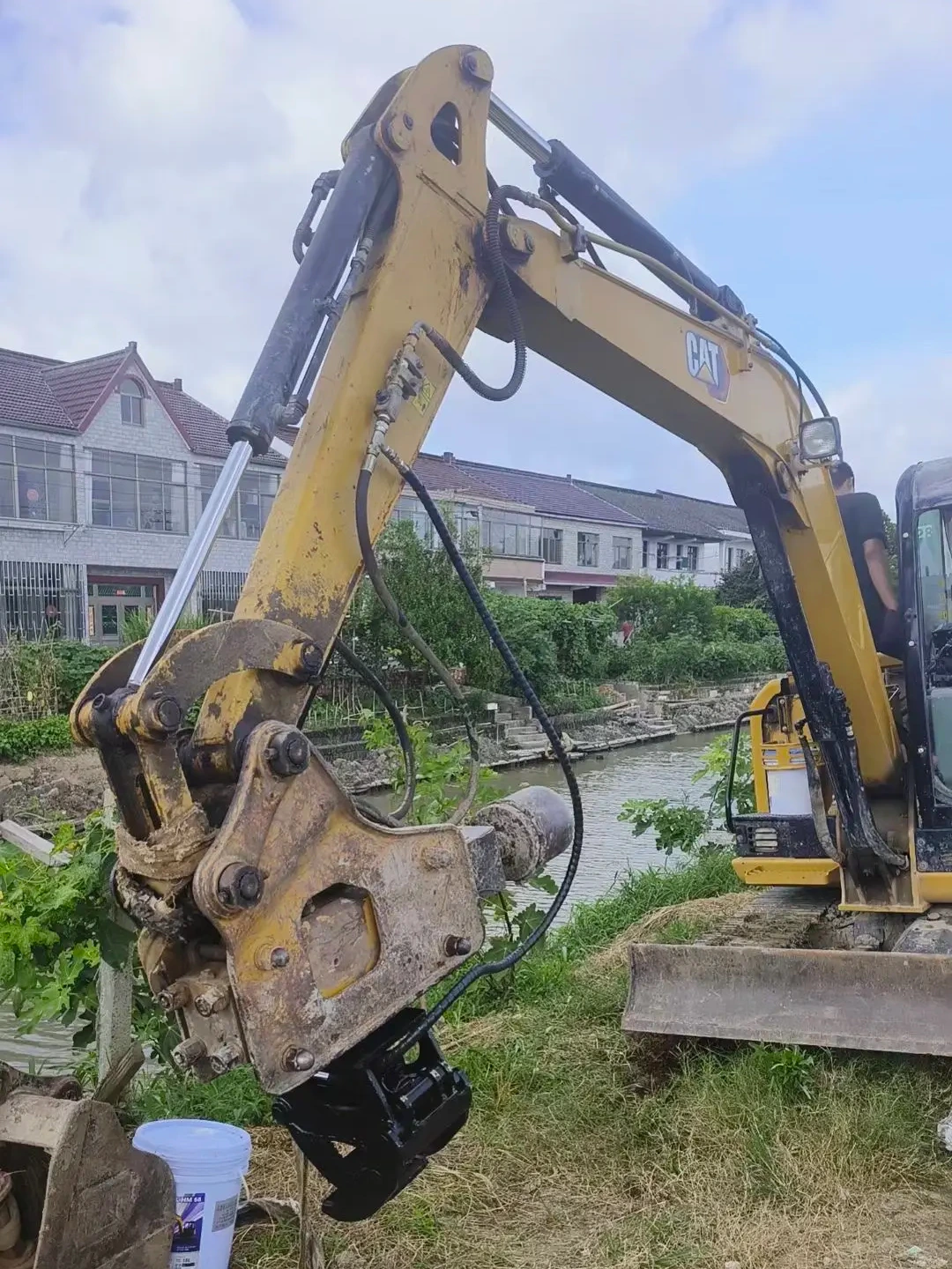 Post driving clamp installed on breaker